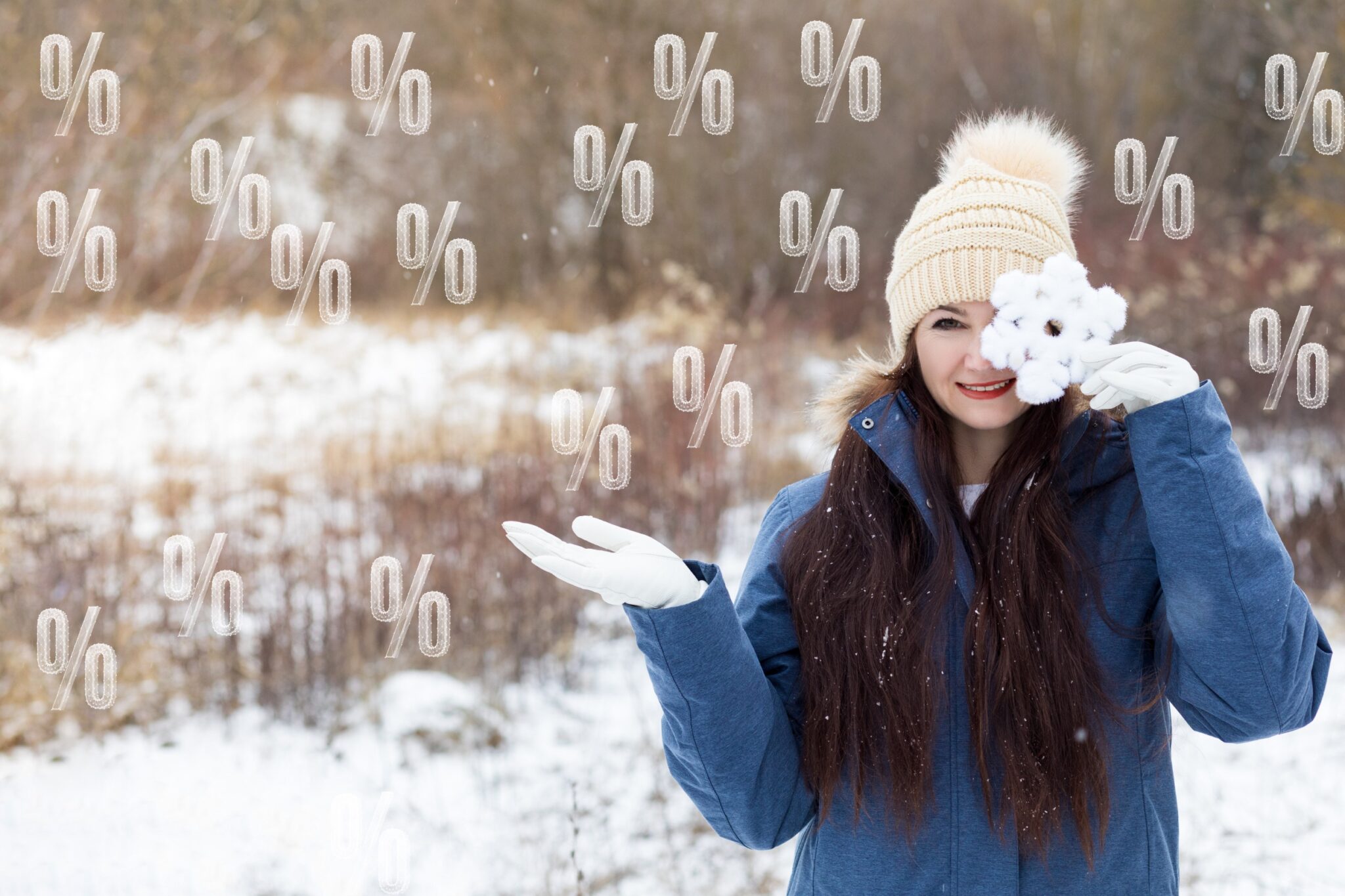 Winter sales and discount concepts. Woman on background of winter landscape and flying percent.